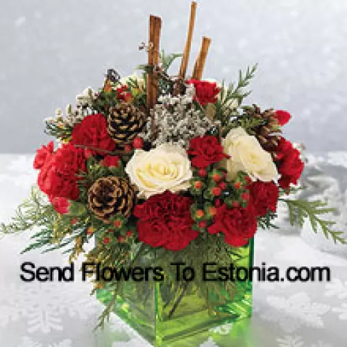 Send this bouquet of holiday colours - white roses, red carnations and Christmas greens - to express your happiest holiday wishes. Arranged in a glass cube with cinnamon sticks and pinecones, it's a wonderful gift for anyone on your list (Please Note That We Reserve The Right To Substitute Any Product With A Suitable Product Of Equal Value In Case Of Non-Availability Of A Certain Product)